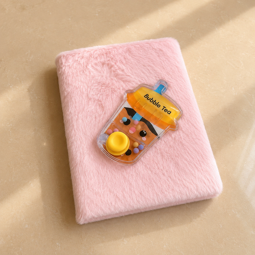 Pink plush notebook with Bubble Tea charm on the cover
